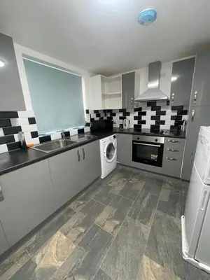 a large kitchen with a washer and dryer in it at Bay Wind Deluxe in Morecambe