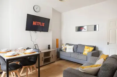 a living room with a couch and a table at Modern 5-Bedroom House with 8 Beds, Perfect for Contractors, Extended Stay Savings in Wallasey