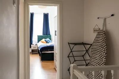 a room with a bedroom with a bed and a doorway at Modern 5-Bedroom House with 8 Beds, Perfect for Contractors, Extended Stay Savings in Wallasey