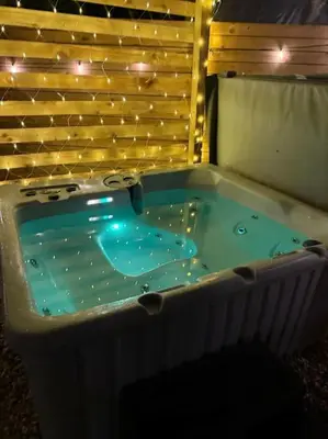 a jacuzzi tub in a room with lights at GGs Holiday Let in Poulton le Fylde