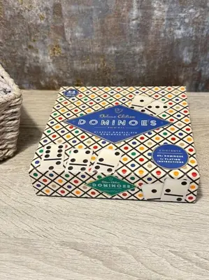 a box of playing cards sitting on a bed at GGs Holiday Let in Poulton le Fylde