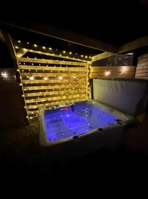 a jacuzzi tub with lights in a dark room at GGs Holiday Let in Poulton le Fylde