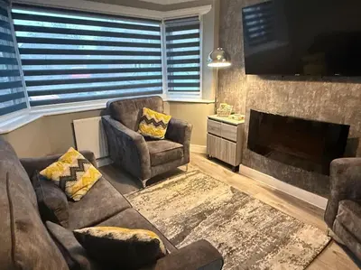 a living room with two couches and a fireplace at GGs Holiday Let in Poulton le Fylde