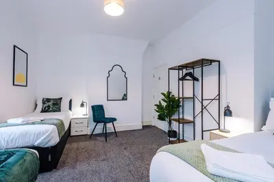 a bedroom with two beds and a desk and a chair at St Paul's by YourStays - 1 Bedroom House in Merseyside in Seacombe