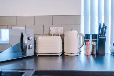 a counter top with a toaster and a coffee maker at St Paul's by YourStays - 1 Bedroom House in Merseyside in Seacombe