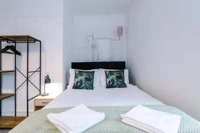 a bedroom with a bed with white sheets and pillows at St Paul's by YourStays - 1 Bedroom House in Merseyside in Seacombe