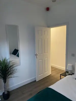 a bedroom with a white door and a mirror at Beautiful & Spacious Suite in Blackpool Centre in Blackpool