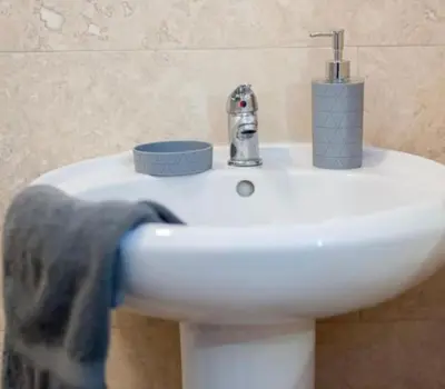a white bathroom sink with a towel on it at Beautiful & Spacious Suite in Blackpool Centre in Blackpool