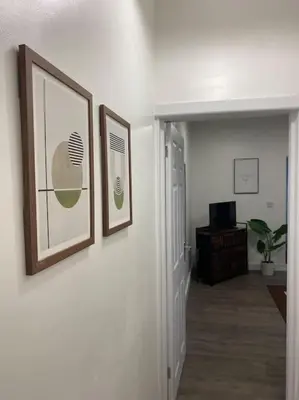 a hallway with two framed pictures on a wall at Beautiful & Spacious Suite in Blackpool Centre in Blackpool