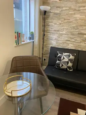 a living room with a glass table and a couch at Beautiful & Spacious Suite in Blackpool Centre in Blackpool