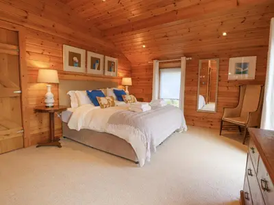 a bedroom with a bed in a wooden cabin at Artisan Lodge in Preston