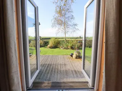 an open door with a view of a yard at Artisan Lodge in Preston