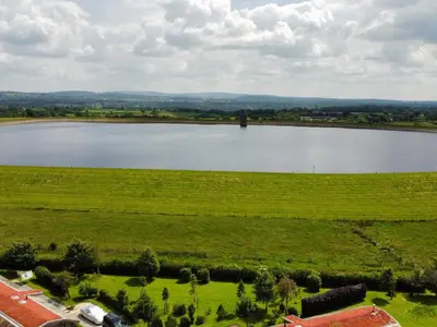 an aerial view of a large lake in a field at Artisan Lodge in Preston