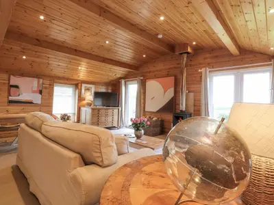 a living room with a couch and a table at Artisan Lodge in Preston