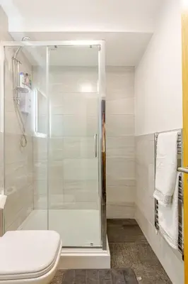 a bathroom with a shower and a toilet at Large 2-Bedroom Apartment, Liverpool City Centre - Sleeps up to 10 in Liverpool