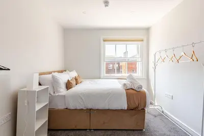 a bedroom with a bed and a window at Large 2-Bedroom Apartment, Liverpool City Centre - Sleeps up to 10 in Liverpool