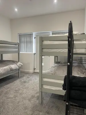 a room with two bunk beds and a chair at Ground Floor - Balmoral Stays - Apartment 2 - Sleeps 6 Free WiFi in Blackpool