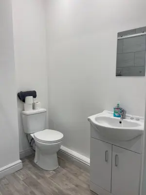 a white bathroom with a toilet and a sink at Ground Floor - Balmoral Stays - Apartment 2 - Sleeps 6 Free WiFi in Blackpool
