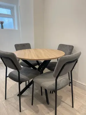 a wooden table with four chairs around it at Ground Floor - Balmoral Stays - Apartment 2 - Sleeps 6 Free WiFi in Blackpool