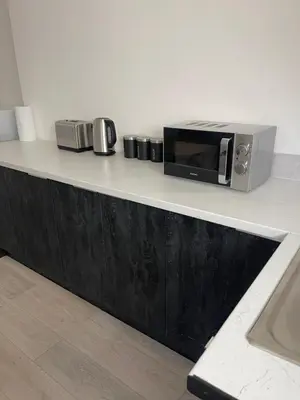 a microwave sitting on top of a counter at Ground Floor - Balmoral Stays - Apartment 2 - Sleeps 6 Free WiFi in Blackpool