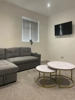 a living room with a couch and a table at Ground Floor - Balmoral Stays - Apartment 2 - Sleeps 6 Free WiFi in Blackpool