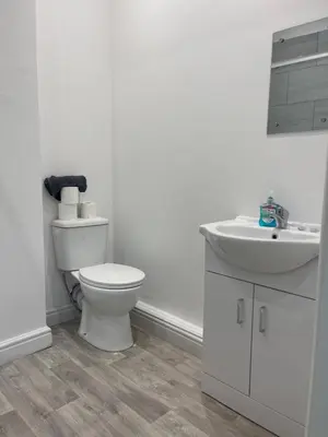 a white bathroom with a toilet and a sink at Ground Floor - Balmoral Stays - Apartment 2 - Sleeps 6 Free WiFi in Blackpool