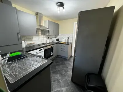 a kitchen with a sink and a refrigerator at Double Bed BW2 Accrington Burnley in Accrington