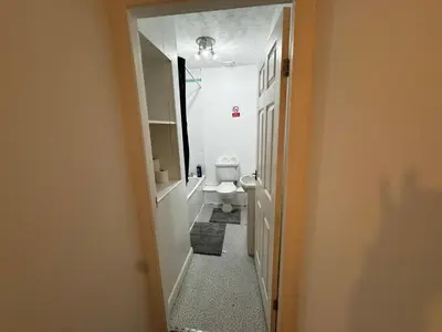 a hallway leading to a bathroom with a toilet at Double Bed BW2 Accrington Burnley in Accrington