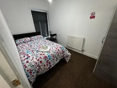 a bedroom with a bed with a comforter on it at Double Bed BW2 Accrington Burnley in Accrington