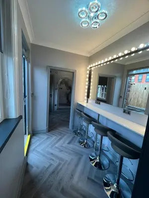 a dressing room with a vanity and a mirror at 101 Bold Street Apartments in Liverpool