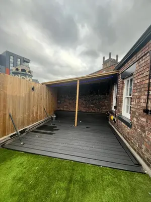 a backyard with a wooden deck next to a brick building at 101 Bold Street Apartments in Liverpool