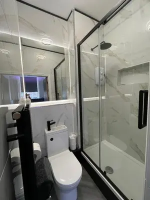 a bathroom with a toilet and a glass shower at 101 Bold Street Apartments in Liverpool