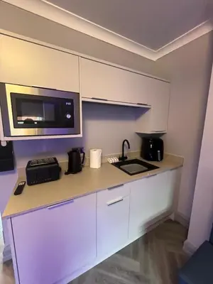 a kitchen with a counter with a sink and a microwave at 101 Bold Street Apartments in Liverpool