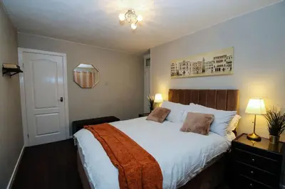 a bedroom with a large bed with white sheets at Swindon Dream in Liverpool