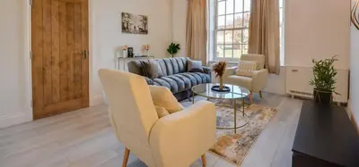 a living room with a couch and a table at Wigan - Apartment - Sleeps 3 - Parking - Stadium in Wigan