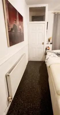a room with two beds and a white door at Luxury King-size Rm in Bolton