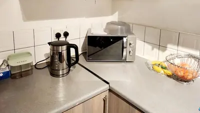 a kitchen with a counter top with a microwave at Luxury King-size Rm in Bolton