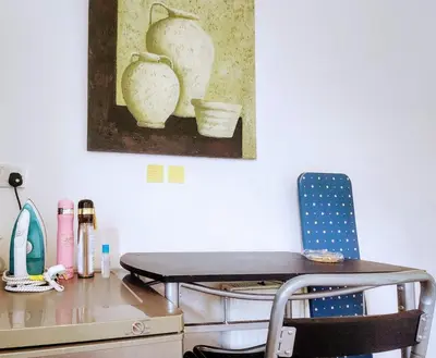 a desk with a chair and a painting on the wall at Luxury King-size Rm in Bolton
