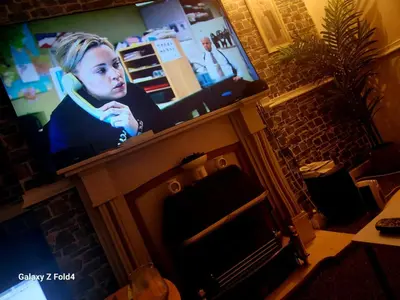 a television screen with a young girl on it at Luxury King-size Rm in Bolton