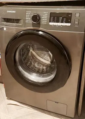 a silver washing machine with its door open at Luxury King-size Rm in Bolton