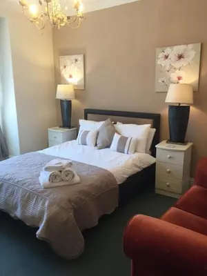 a bedroom with a bed with two towels on it at The Fernroyd in Blackpool
