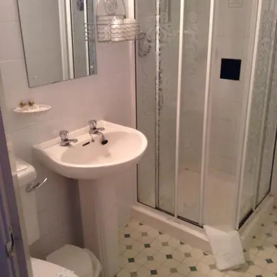 a bathroom with a sink and a shower at The Fernroyd in Blackpool