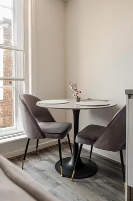 a table and chairs in a room with a window at Spacious 2Bed Central Liverpool Nightlife & Events, sleeps up to 10 in Liverpool