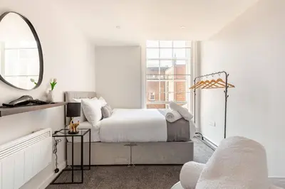 a white bedroom with a bed and a mirror at Spacious 2Bed Central Liverpool Nightlife & Events, sleeps up to 10 in Liverpool