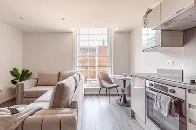 a kitchen and living room with a couch and a table at Spacious 2Bed Central Liverpool Nightlife & Events, sleeps up to 10 in Liverpool