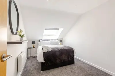 a small bedroom with a bed with a window at 2-Bed Apartment with Sofa Bed, Sleeps up to 6, Perfect for Groups & Familie in Liverpool