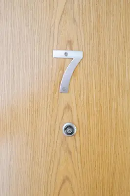 a wooden door with a number seven on it at 2-Bed Apartment with Sofa Bed, Sleeps up to 6, Perfect for Groups & Familie in Liverpool