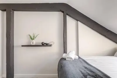 a bedroom with a bed with a wooden headboard at 2-Bed Apartment with Sofa Bed, Sleeps up to 6, Perfect for Groups & Familie in Liverpool