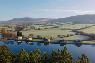an aerial view of a river with houses and fields at Glenmoor Lodge in Clitheroe
