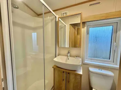a bathroom with a toilet and a sink and a shower at Glenmoor Lodge in Clitheroe